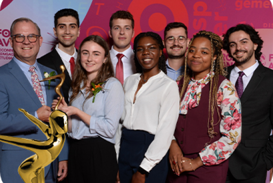 diverse group of students smiling holding award