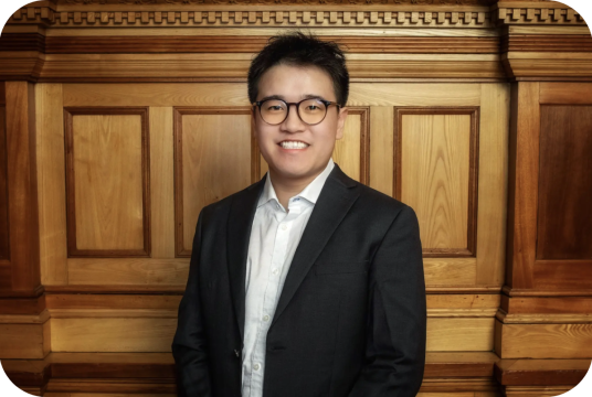 smiling man with classes in white button down shirt and suit