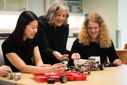 Students and professor demo an educational activity