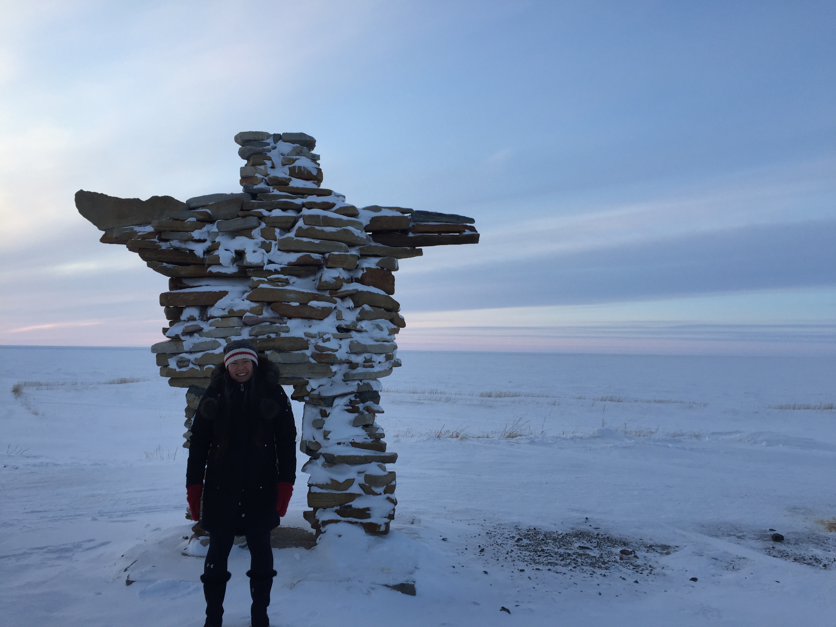 Christine Ha in front of an Inukshuk