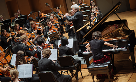Orchestra playing with pianist
